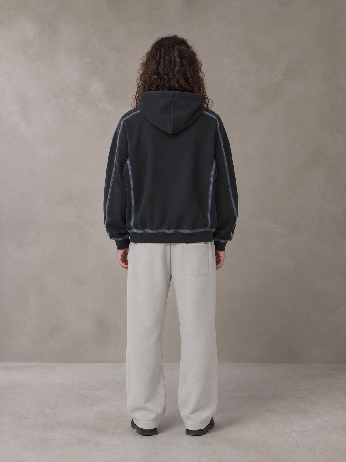 Model wearing the SM Sig. Straight Leg Sweatpants in Pure Grey, rear view.