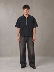 Model wearing the SM Shadowline Denim Zip T-shirt in Midnight Black, front view.