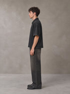 Model wearing the SM Shadowline Denim Zip T-shirt in Midnight Black, side profile.