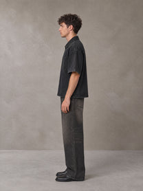 Model wearing the SM Shadowline Denim Zip T-shirt in Midnight Black, side profile.