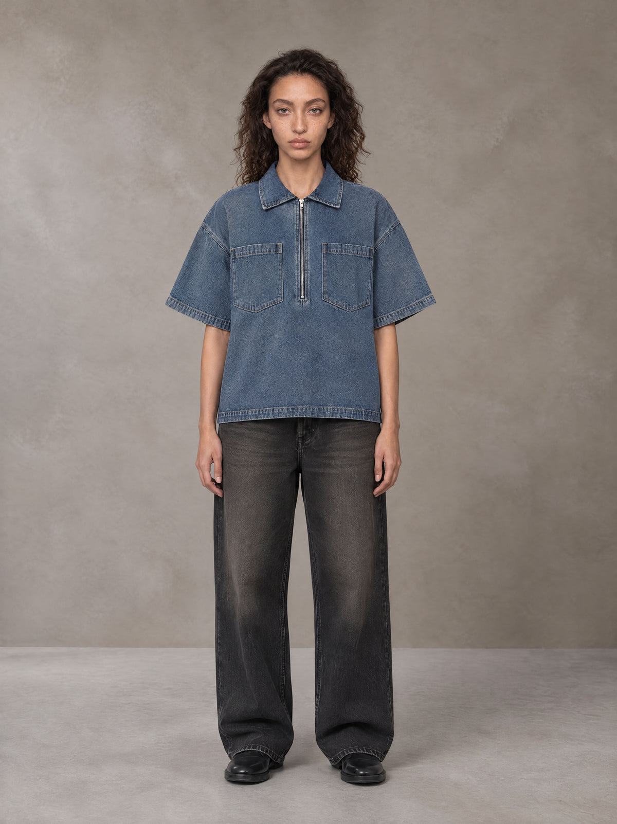 Model wearing the SM Shadowline Denim Zip T-shirt in Slate Blue, front view.