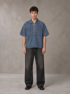 Model wearing the SM Shadowline Denim Zip T-shirt in Slate Blue, front view.