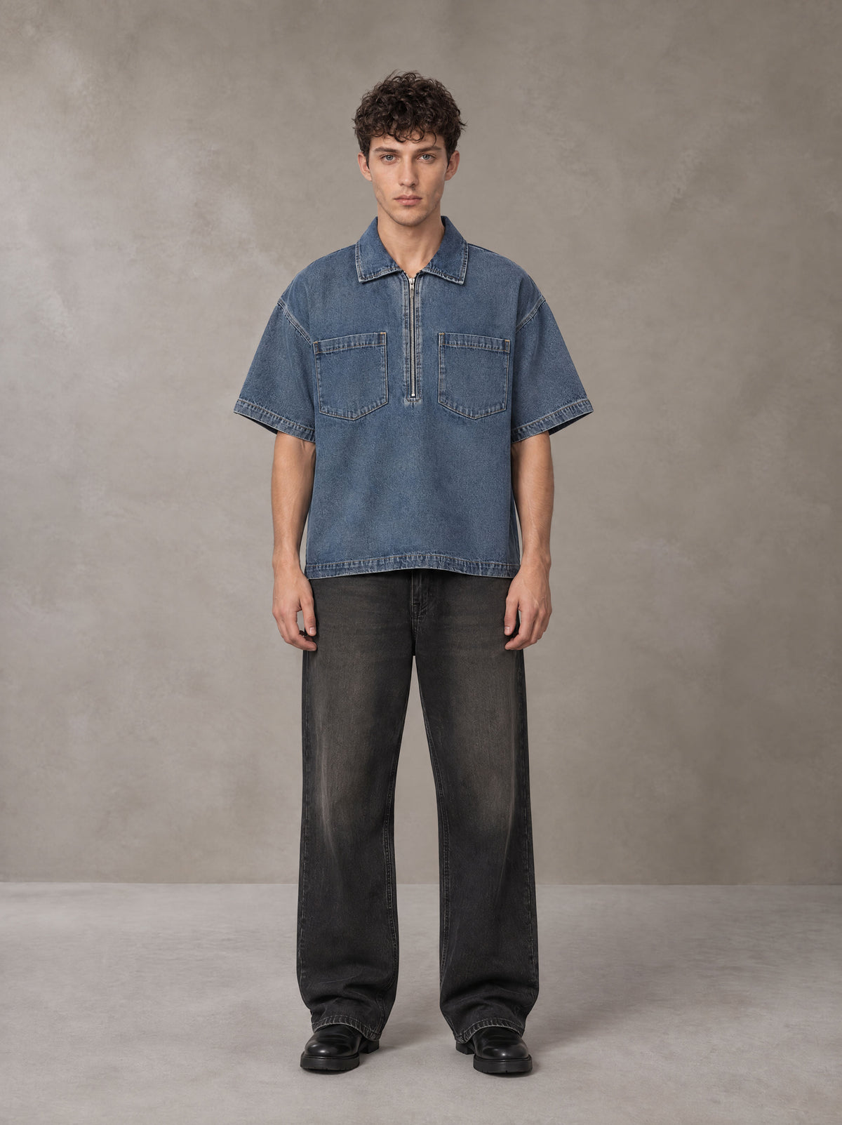 Model wearing the SM Shadowline Denim Zip T-shirt in Slate Blue, front view.