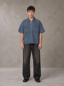 Model wearing the SM Shadowline Denim Zip T-shirt in Slate Blue, front view.