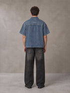 Model wearing the SM Shadowline Denim Zip T-shirt in Slate Blue, rear view.