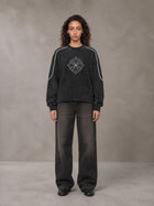 Model wearing the SM Fleur Eclipse Sweatshirt in Midnight Black, front view.