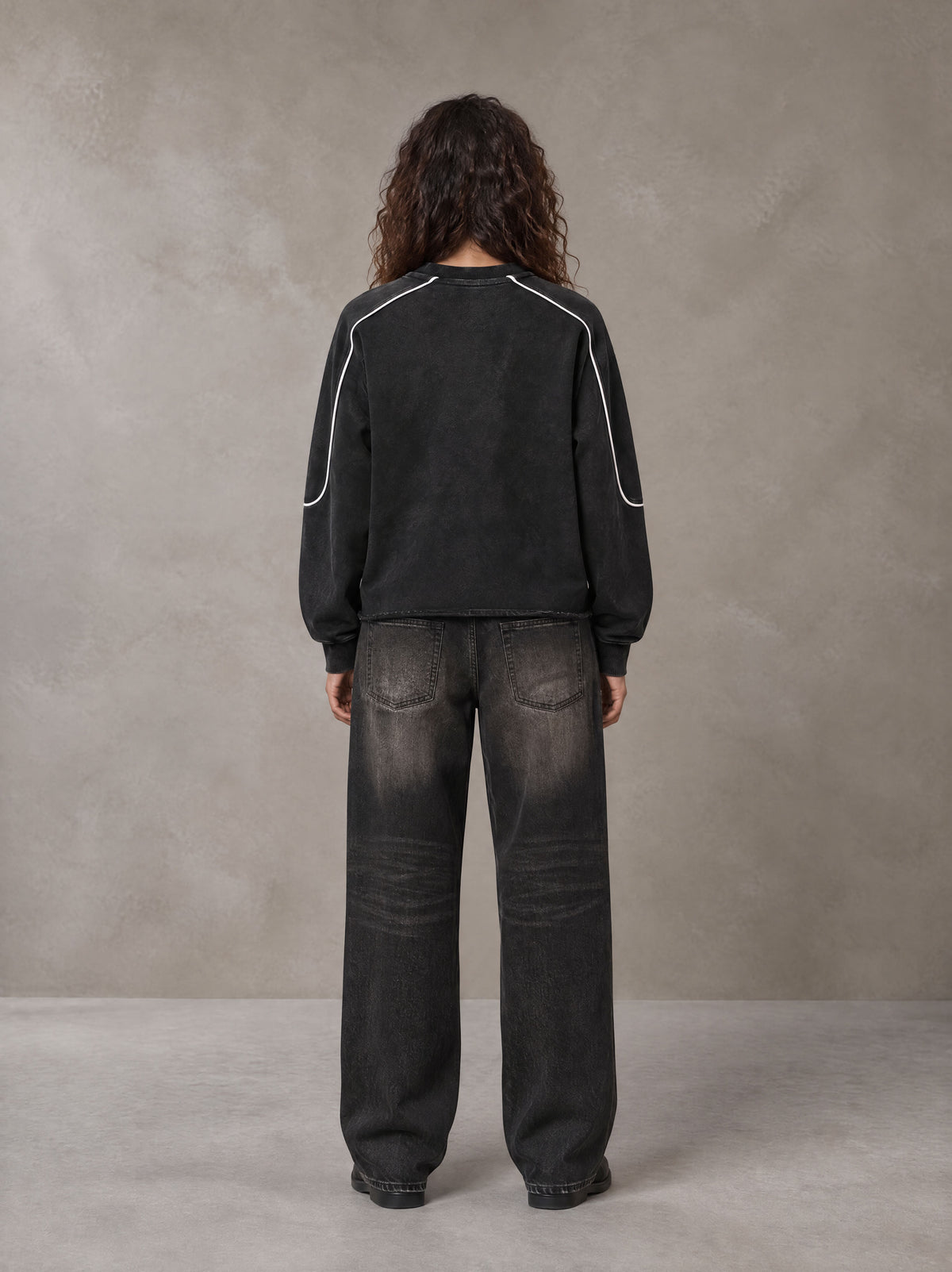 Model wearing the SM Fleur Eclipse Sweatshirt in Midnight Black, rear view.