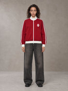 Model wearing the SM Insignia Contrast Trim Jacket in Deep Carmine, front view.