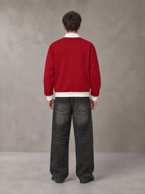Model wearing the SM Insignia Contrast Trim Jacket in Deep Carmine, rear view.