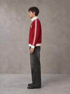 Model wearing the SM Insignia Contrast Trim Jacket in Deep Carmine, side profile.