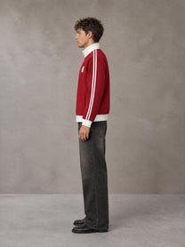 Model wearing the SM Insignia Contrast Trim Jacket in Deep Carmine, side profile.