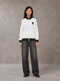Model wearing the SM Insignia Contrast Trim Jacket in Lucent White, front view.