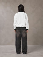 Model wearing the SM Insignia Contrast Trim Jacket in Lucent White, rear view.