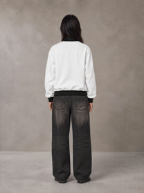 Model wearing the SM Insignia Contrast Trim Jacket in Lucent White, rear view.
