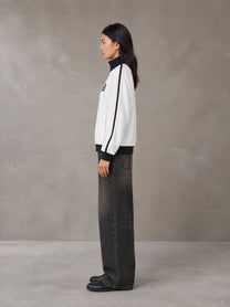Model wearing the SM Insignia Contrast Trim Jacket in Lucent White, side profile.