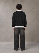 Model wearing the SM Insignia Contrast Trim Jacket in Midnight Black, rear view.