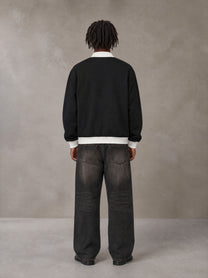Model wearing the SM Insignia Contrast Trim Jacket in Midnight Black, rear view.