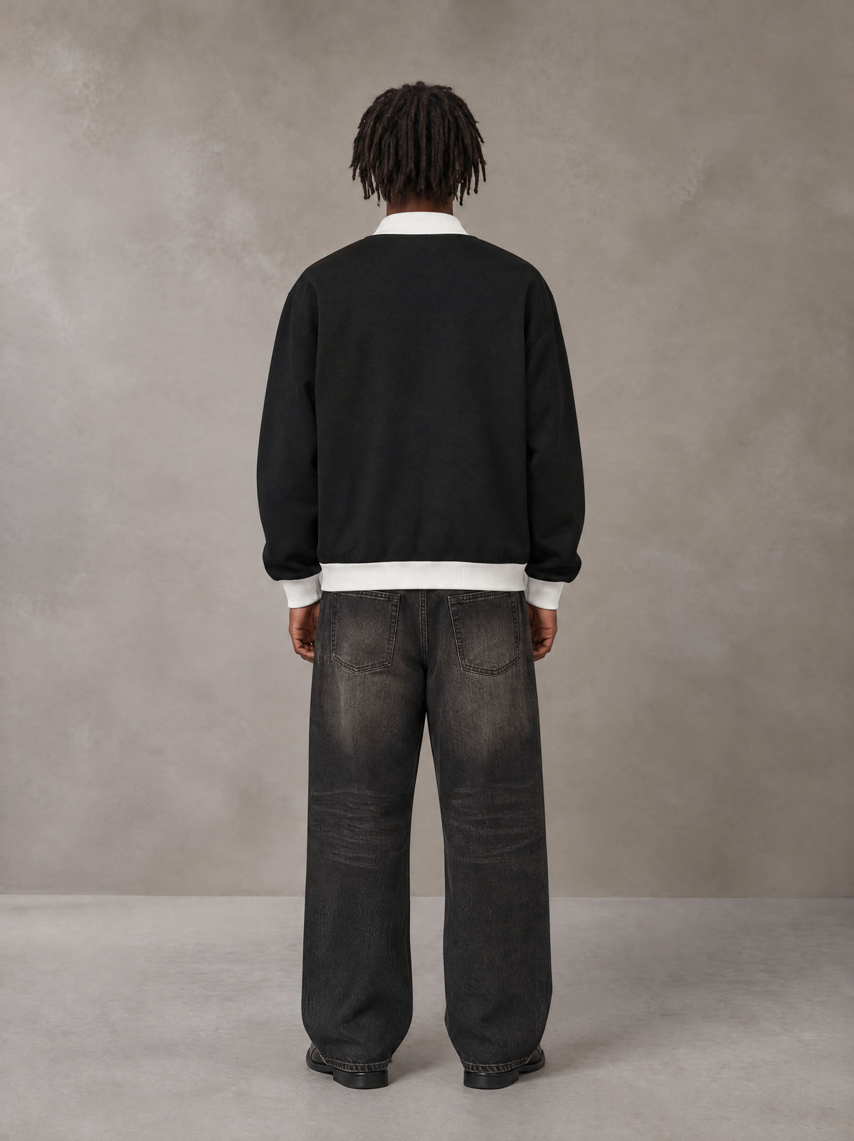 Model wearing the SM Insignia Contrast Trim Jacket in Midnight Black, rear view.