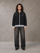 Model wearing the SM Insignia Hoodie in Midnight Black, front view.
