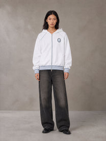 Model wearing the SM Insignia Hoodie in Lucent White, front view.