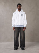 Model wearing the SM Insignia Hoodie in Lucent White, front view.