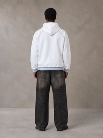 Model wearing the SM Insignia Hoodie in Lucent White, rear view.