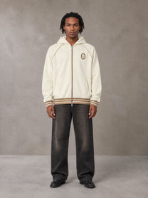 Model wearing the SM Insignia Hoodie in Soft Beige, front view.