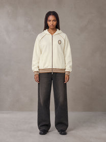 Model wearing the SM Insignia Hoodie in Soft Beige, front view.