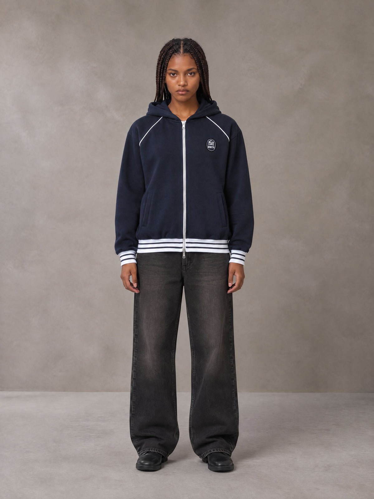 Model wearing the SM Insignia Hoodie in Oxford Navy, front view.