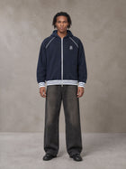 Model wearing the SM Insignia Hoodie in Oxford Navy, front view.