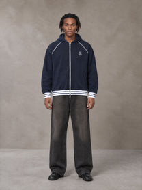 Model wearing the SM Insignia Hoodie in Oxford Navy, front view.