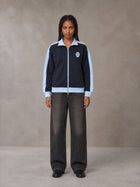 Model wearing the SM Insignia Jacket in Oxford Navy, front view.