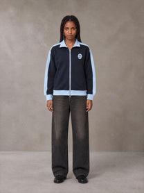 Model wearing the SM Insignia Jacket in Oxford Navy, front view.