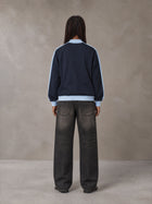 Model wearing the SM Insignia Jacket in Oxford Navy, rear view.