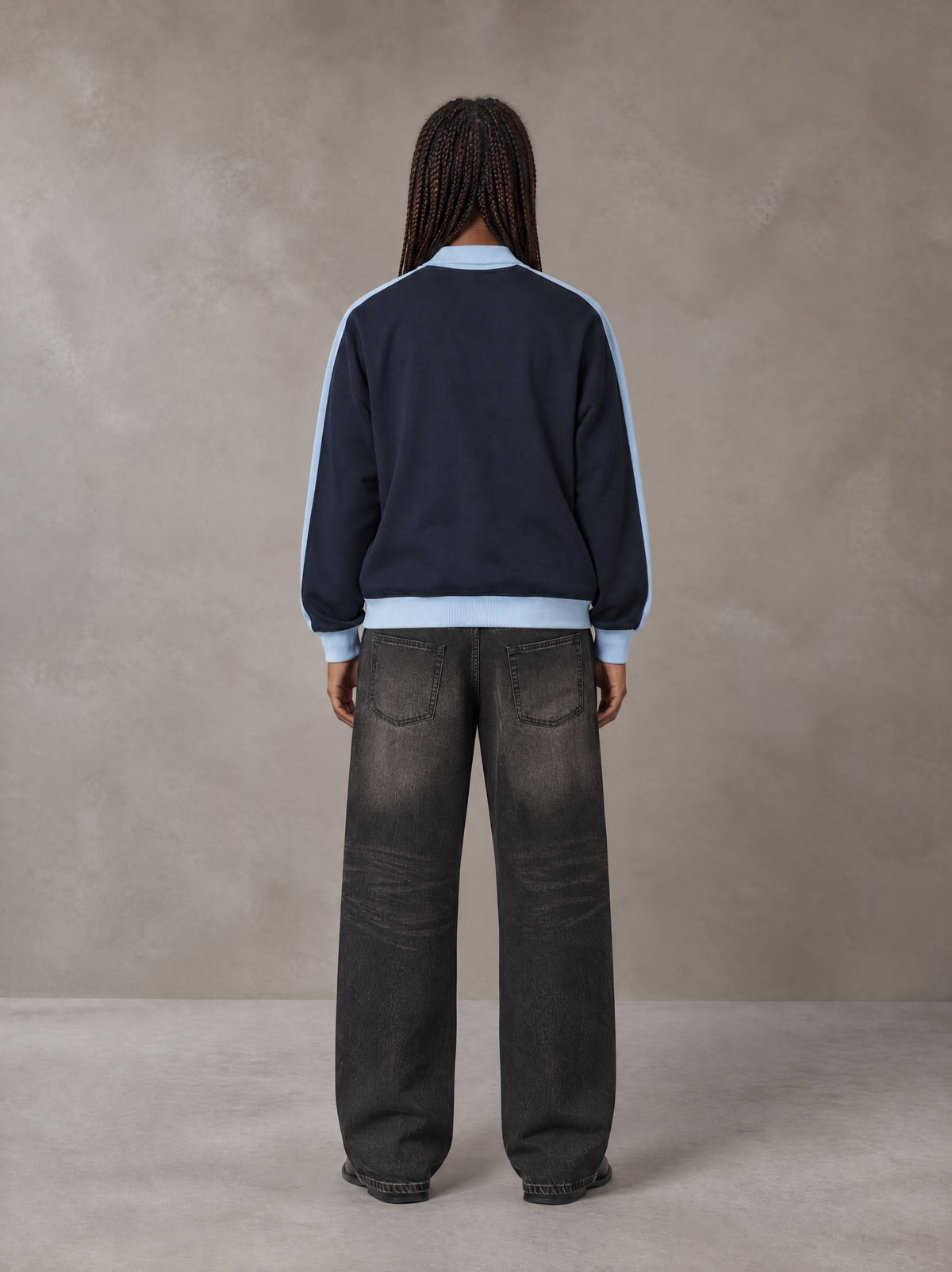 Model wearing the SM Insignia Jacket in Oxford Navy, rear view.