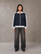Model wearing the SM Insignia Jacket in Oxford Navy, front view.
