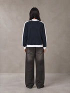 Model wearing the SM Insignia Jacket in Oxford Navy, rear view.