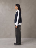 Model wearing the SM Insignia Jacket in Oxford Navy, side profile.