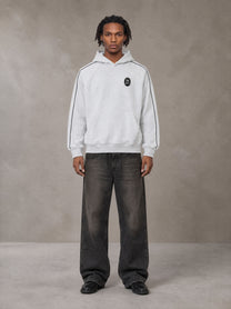Model wearing the SM Insignia Parallel Hoodie in Floral Grey, front view.