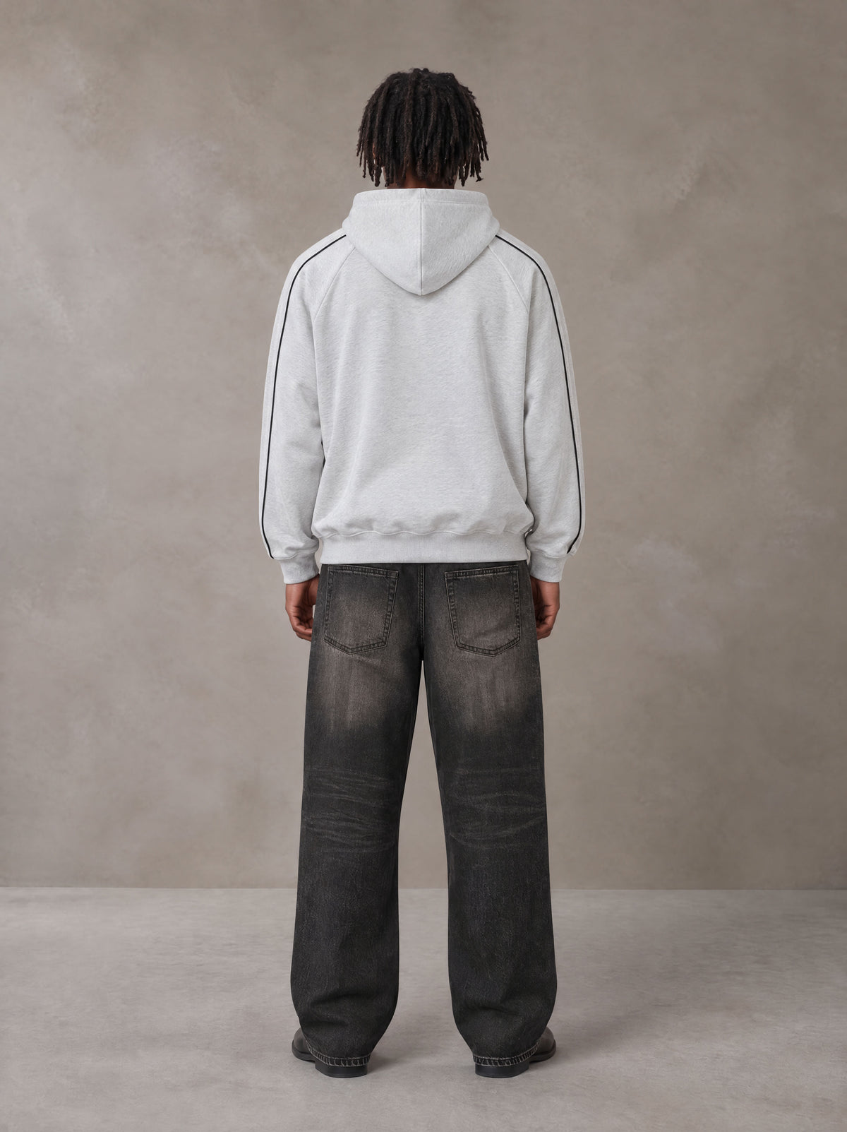 Model wearing the SM Insignia Parallel Hoodie in Floral Grey, rear view.