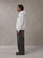 Model wearing the SM Insignia Parallel Hoodie in Floral Grey, side profile.