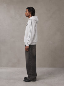 Model wearing the SM Insignia Parallel Hoodie in Floral Grey, side profile.
