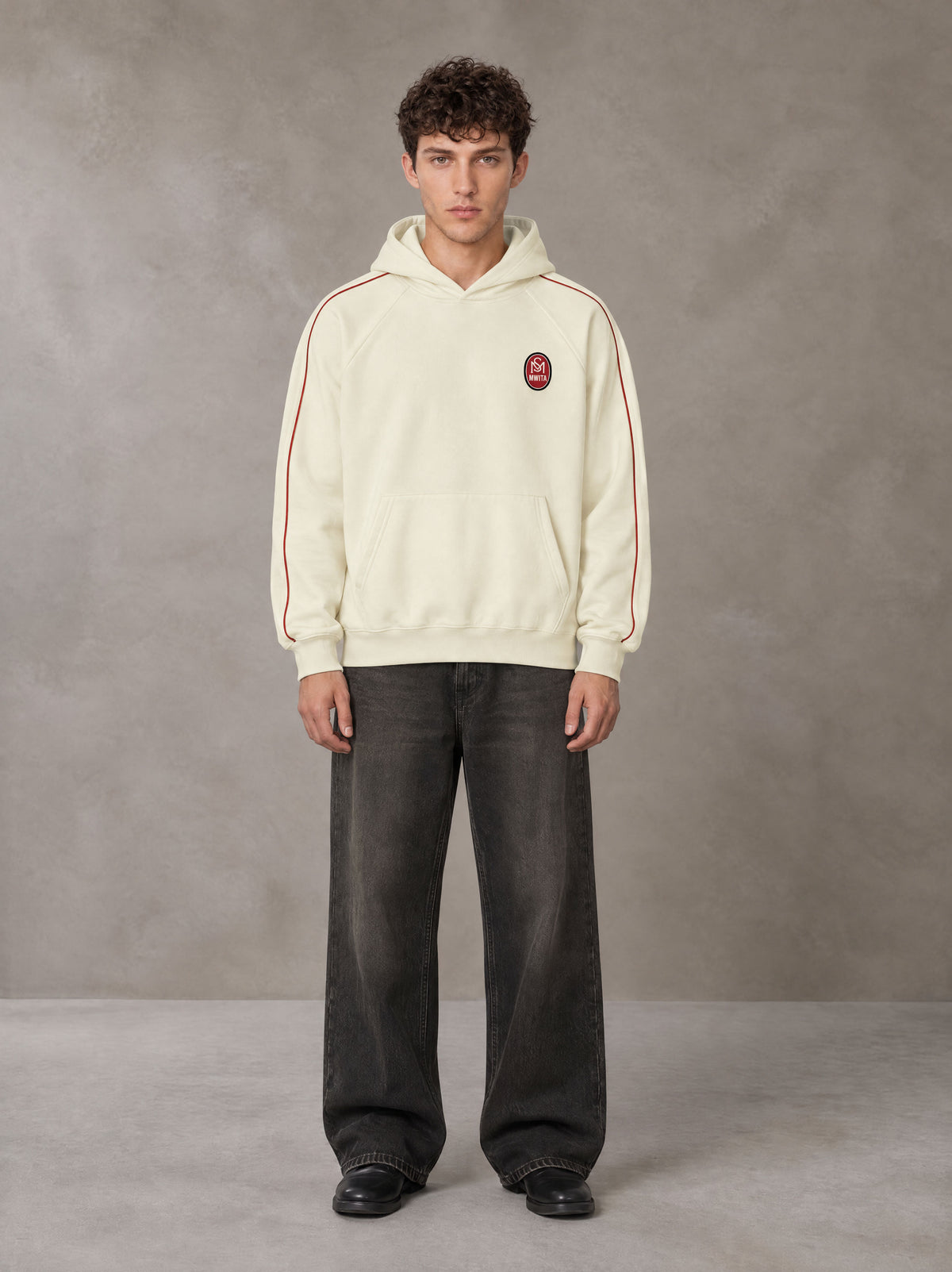 Model wearing the SM Insignia Parallel Hoodie in Classic Cream, front view.