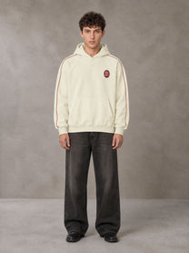 Model wearing the SM Insignia Parallel Hoodie in Classic Cream, front view.