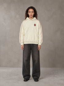 Model wearing the SM Insignia Parallel Hoodie in Classic Cream, front view.