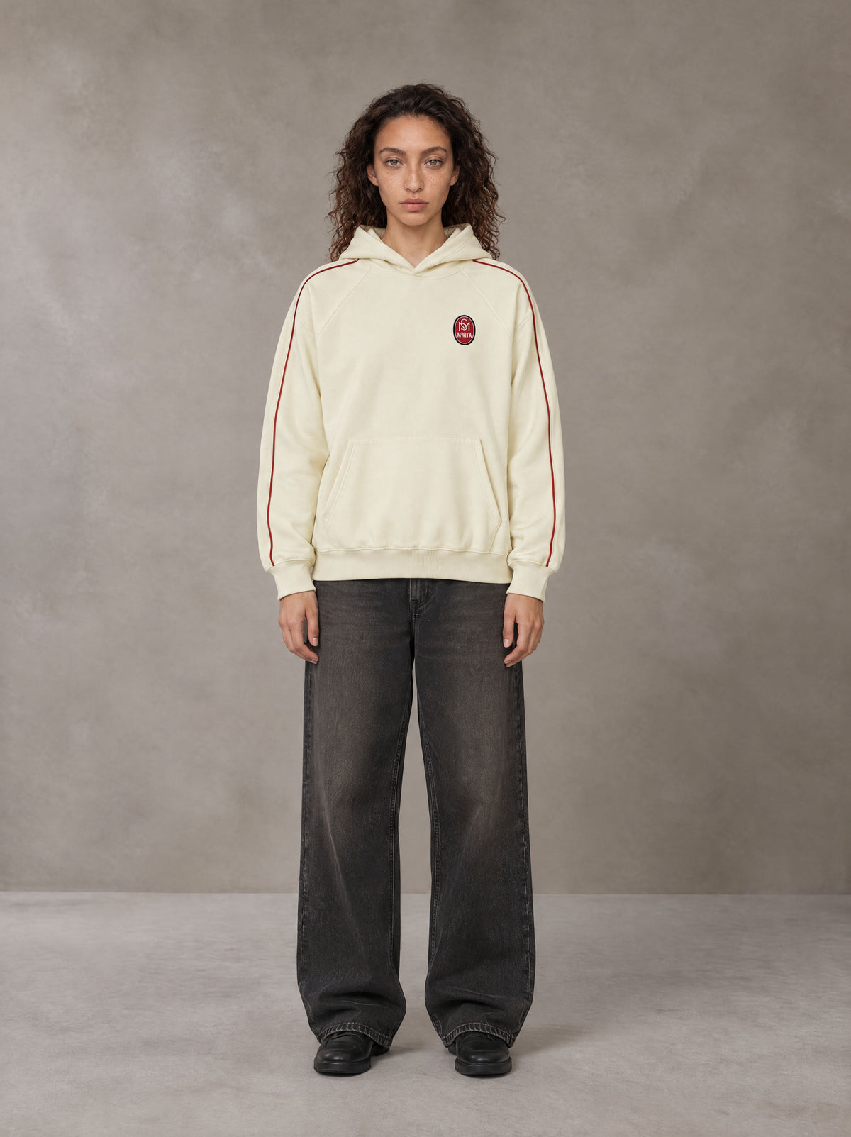 Model wearing the SM Insignia Parallel Hoodie in Classic Cream, front view.