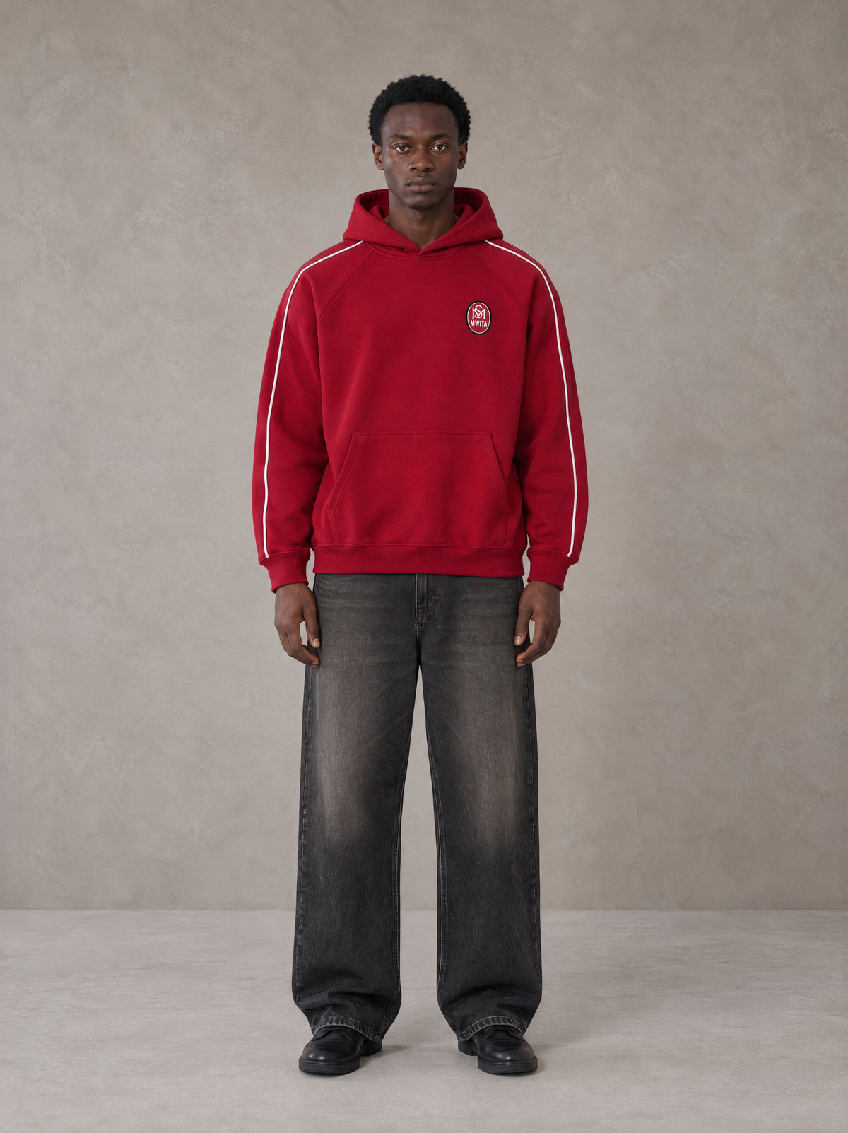 Model wearing the SM Insignia Parallel Hoodie in Carmine, front view.