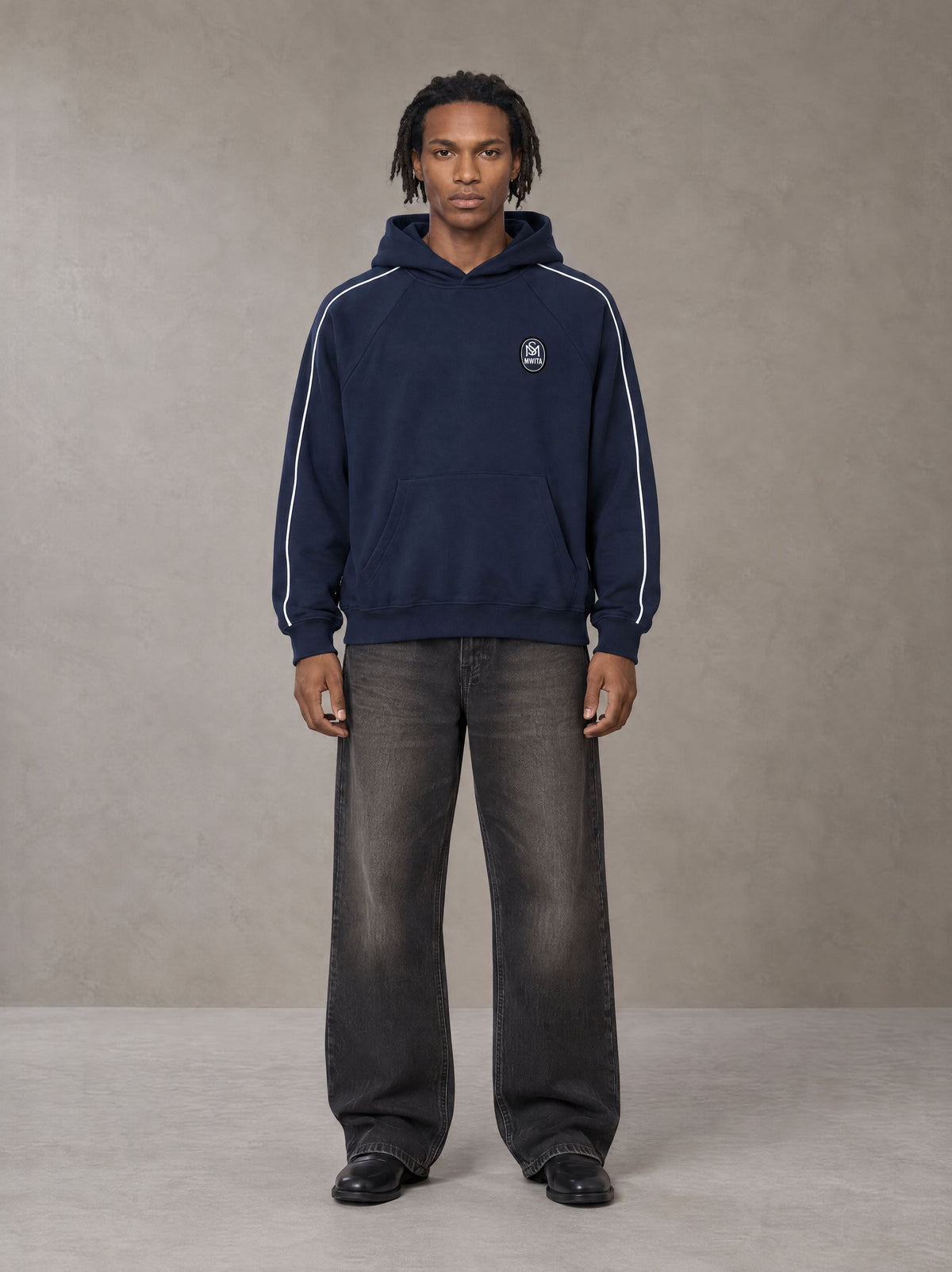 Model wearing the SM Insignia Parallel Hoodie in Oxford Navy, front view.