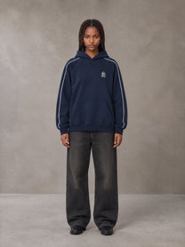 Model wearing the SM Insignia Parallel Hoodie in Oxford Navy, front view.