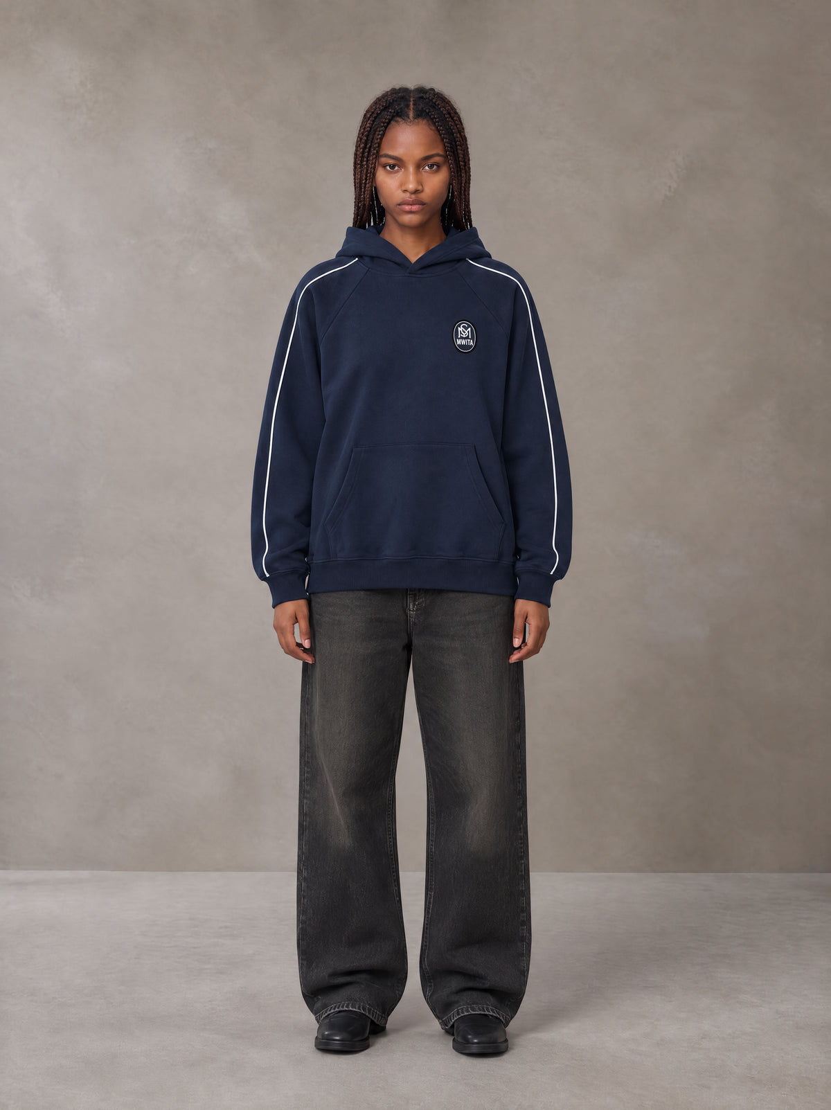 Model wearing the SM Insignia Parallel Hoodie in Oxford Navy, front view.